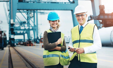 Mature man, woman and logistics at port in portrait, smile or helmet by rail for supply chain...