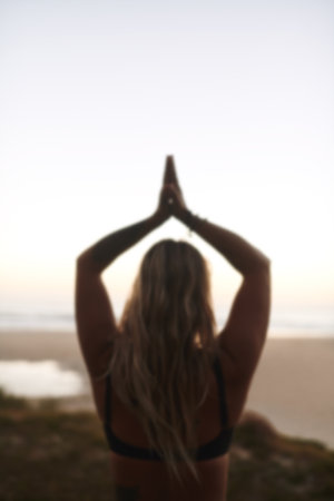 Back, beach and woman with namaste for meditation, wellness or inner peace for mindfulness outdoor. Nature, female person and yogi with prayer hands for yoga, mental health or zen for holistic energyの写真素材