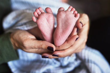 Baby, feet and hands in home with love, support and bonding together with newborn and care. Parent,...