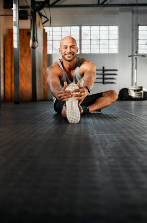 Portrait, man and legs with stretching for training, balance and prevention of muscle tension in gym. Space, happy and bodybuilder with warm up for wellness, exercise journey or endurance for fitnessの写真素材