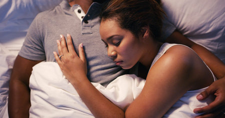 Couple, hug and sleep in bed at house for relax, love and fatigue together with rest, break and night. Man, woman and cuddle in home bedroom for comfort, exhausted and tired on chest with weekendの写真素材