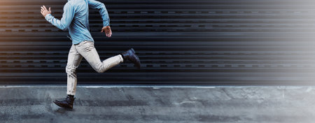 Man, urban fashion and running with space, casual style and speed in city for office and job. Clothes, lens flare or late person chasing dreams for career opportunity, travel or ambition in New Yorkの写真素材