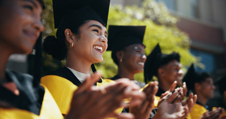 Students, happy and applause at university for graduation, peer support or cheering for achievement....