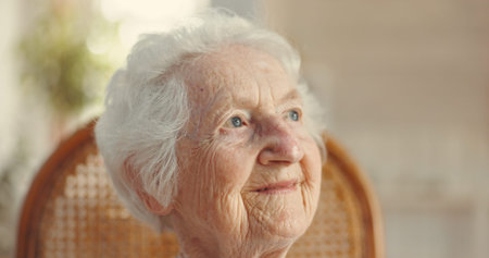 Thinking, senior woman and smile at retirement home for past life, nostalgia and remember with...