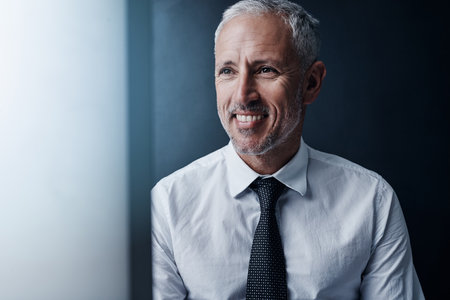 Manager, thinking and happy business man with idea, inspiration or mindset on background. Mature CEO, smile and planning future in office for investment, professional insight and vision for solutionの写真素材