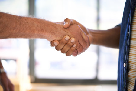 Shaking hands, office and closeup for agreement, deal or welcome with greeting, respect or teamwork. People, handshake and introduction in collaboration, success or congratulations at creative agencyの写真素材