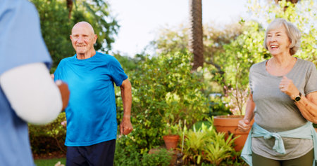 Physiotherapy, class and coaching with old people, nurse outdoor for help for healthcare and support. Medical, rehabilitation and retirement with senior patient in nursing home for fitness clubの写真素材