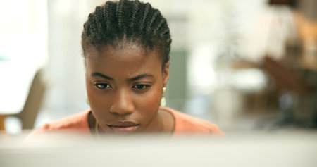Black woman, computer and thinking for office job, employee and working for copywriter career. Businesswoman, reading and person for occupation, workplace and worker for company, face or seriousの写真素材