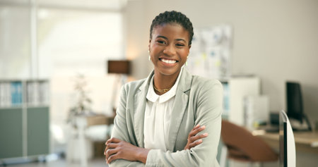Portrait, happy and a business black woman arms crossed in a corporate office as a professional....