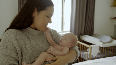 Parent, newborn and mother with child as love, care or bonding in a home as affection together. Sleeping, support and mom relax in bedroom with kid as family in house for childcare and comfortの写真素材