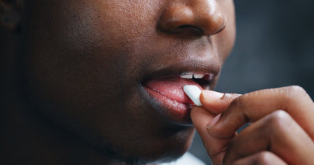 Closeup, mouth and fresh breathe with gum for oral hygiene, dental health or peppermint on gray studio background. Mint candy or model with chewing tablet for orthodontics, clean teeth or bubblegumの写真素材