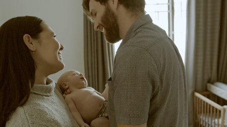 Couple, newborn and parents love baby as support, care or bonding in a home as fun, affection or...