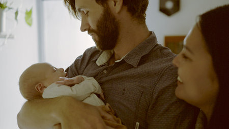 Parents, hug or dad with newborn in a family for care, love or bond together for child development....