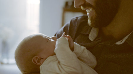 Happy, hug or father with baby in home for love, care or bond together to nurture child development. Closeup, newborn or single parent dad with infant for support, trust or comfort in family houseの写真素材