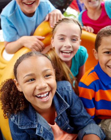 Children, slide and social playground for friends, playing group and portrait for diversity. Kids, closeup and outside games for development at school academy, students break and bonding togetherの写真素材
