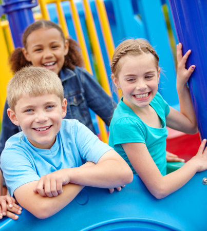 Happy kids, portrait or friends on playground activity playing on outdoor holiday or vacation with games. Growth development, fun park or children with smile, group or joy for adventure or wellnessの写真素材