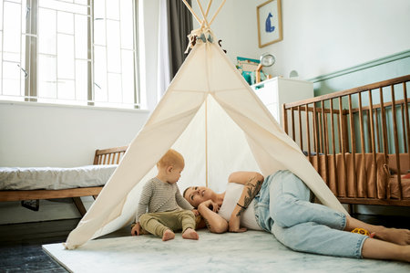 Mother, baby and tent in family home for play, bonding and development on floor with love, care and...