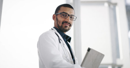 Clinic, smile and doctor with tablet, portrait and man with diagnosis for cure, low angle and space....