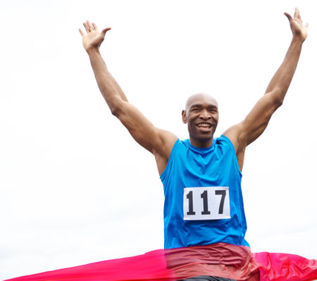 Running, winner and black man on track for race, challenge or marathon for charity event. Sports, mockup space and African athlete cheering by finish line for cardio workout, exercise or training.の写真素材