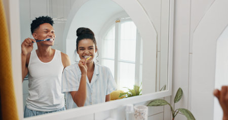 Brushing teeth, morning and reflection with couple in bathroom for dental hygiene or oral care....