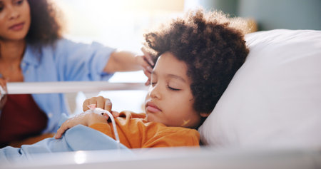 Sick child, mother and sleeping in hospital bed for healthcare, wellness and surgery recovery. Mom, kid and patient resting in clinic for medical support, comfort and healing illness with familyの写真素材
