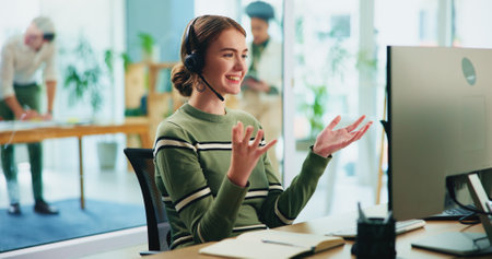 Happy, woman and headset with computer in call centre of communication, customer service and ecommerce. Smile, female agent and talking with mic of telemarketing help, website faq and online solutionの写真素材