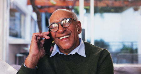Phone call, laughing and senior man in home, living room and conversation with contact and happy....