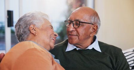 Happy, bonding and senior couple relaxing in home for love, marriage and connection together. Smile,...