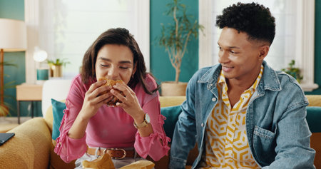 Eating, couple and delicious food for woman, home and people with meal in living room, smile or...