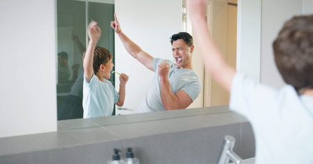 Singing, dental health and father brushing teeth with child in bathroom for preventing gum disease....