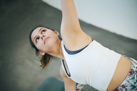 Yoga, woman and triangle exercise for workout, training and fitness of athlete, pilates and energy...