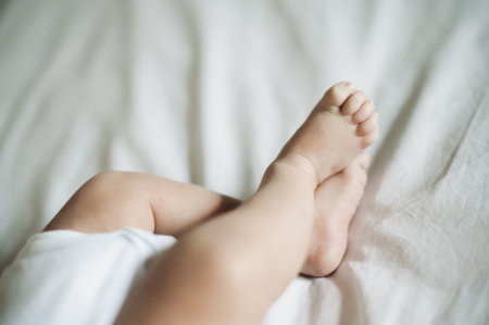 Baby feet, closeup and infant foot on a nursery bed ready for sleeping, morning rest and nap....