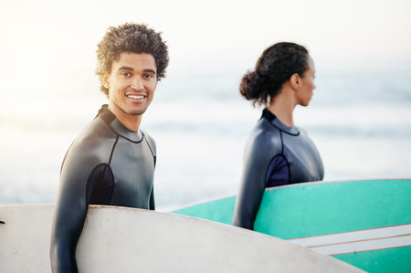 Portrait, sports and a surfing man on the beach with a friend during summer for fun or recreation....