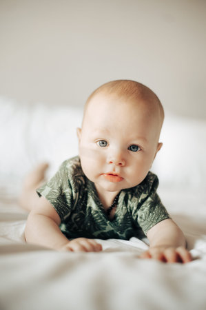 Portrait, children and cute with a baby boy on a bed in a bedroom of a home alone for child...