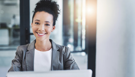 Happy, professional and portrait of businesswoman in office with company revenue, profit or dividend report. Smile, pride and female financial analyst from Brazil with finance career development.の写真素材