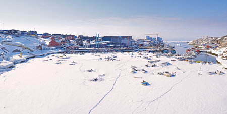 Snow, village and harbor by ocean for travel, fishing or journey by sea. Boats, sailing vessel and...