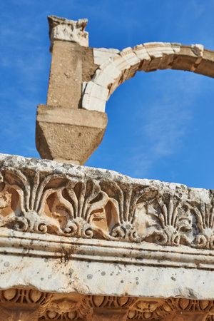 Architecture, ancient and temple with archway in nature for antique, building history or low angle. Culture, ruins and travel with concrete landmark outdoor in Greece for stone sculpture or heritageの写真素材