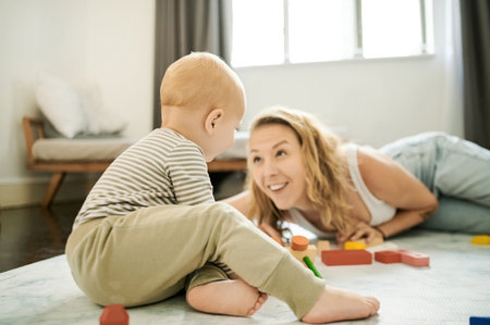 Building blocks, learning and toys with mother and child playing in family home bedroom for fun....