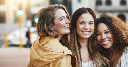 Portrait, laughing and women hug in city, holiday travel and bonding together for friendship. Joke,...