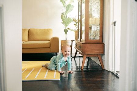 Kids, growth and a baby crawling in the living room of a home during child development with...