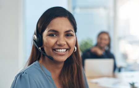 Portrait, happy woman and headset in call center for customer support, telemarketing and contact in India. Consultant, smile and tech in agency for services, CRM and professional virtual assistantの写真素材