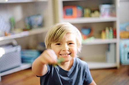 Happy, smile and portrait of boy child in his nursery playing with his toys for childhood development. Happiness, excited and face of toddler kid from Australia having fun in his playroom in his homeの写真素材