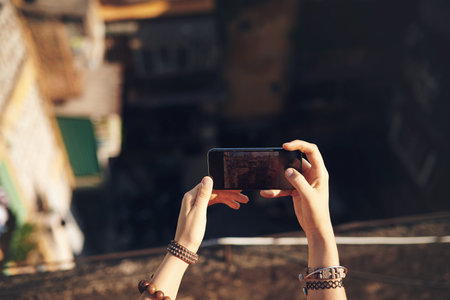 Travel, phone screen and hands of woman with memory, buildings and outdoor city adventure on...