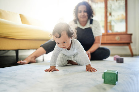 Family, home and baby crawl with mother in living room for growth, relationship and motherhood. Love, child development and happy mom and kid for bonding, quality time and relax together on floorの写真素材