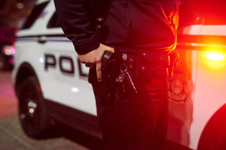 Police, hand and detective with man at night for crime investigation unit, forensic and law enforcement. Justice, security guard and closeup with person for safety officer, emergency and surveillanceの写真素材