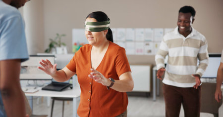 Blindfold, team building and trust with business people in office for communication skills development. Coordination, directions or instructions with employee group in creative workplace for bondingの写真素材