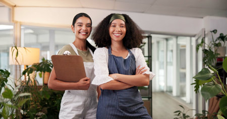 Portrait, women and smile as florist with clipboard, plants inventory and ecommerce order. People, teamwork and flower checklist with floral bookkeeping, supply chain information and stock managementの写真素材