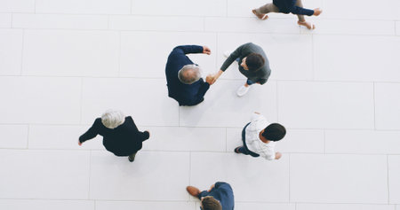 Business people, top view and handshake for merger in office, negotiation success and acquisition....