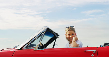 Portrait, road trip and smile of woman in convertible for adventure, break or travel on blue sky. Holiday, summer and vacation with happy person outdoor in sports car for drive, journey or transportの写真素材