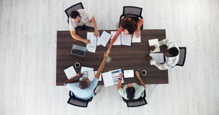 Above, success and handshake with business people in meeting for event planning, budget approval or...